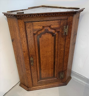 Lot 3331 - A George III oak corner cupboard, with a...
