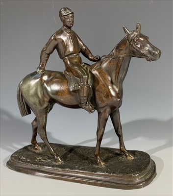 Lot 392 - A spelter figure of a jockey on horseback.