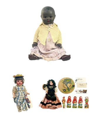 Lot 703 - Large black composition baby doll