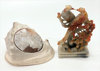 Lot 429 - A conch shell, the oval cameo carved with a...