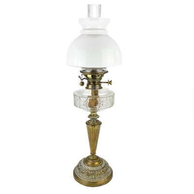 Lot 220 - A Victorian brass oil lamp with a glass reservoir and a white glass shade.