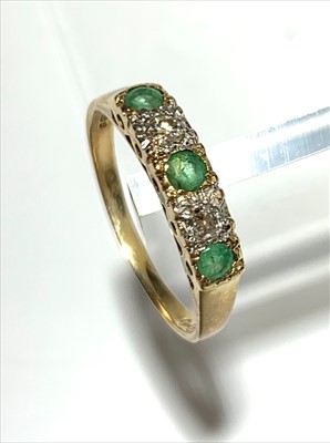 Lot 2526 - A 9ct gold ring set two diamonds and three...