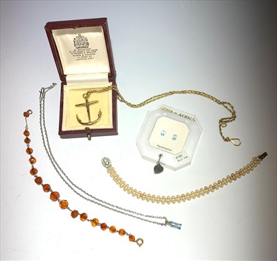 Lot 2678 - A gilt anchor pendant and chain, two unmounted...