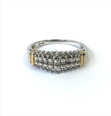 Lot 2683 - A 10ct gold ring with rows of diamonds.