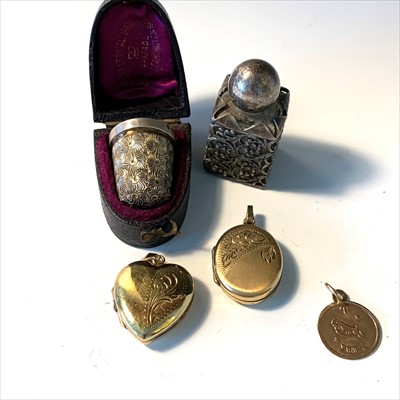 Lot 2653 - Two lockets, gold charm, single ear stud of...