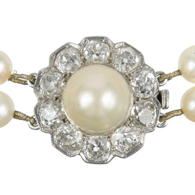 Lot 217 - An impressive early 20th century cultured pearl, diamond set, double-row necklace & earrings suite.