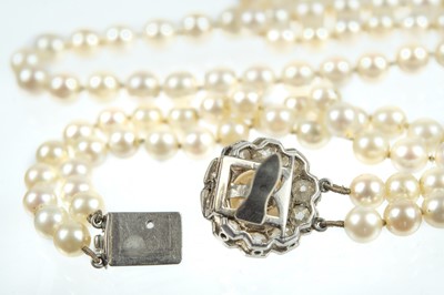 Lot 217 - An impressive early 20th century cultured pearl, diamond set, double-row necklace & earrings suite.