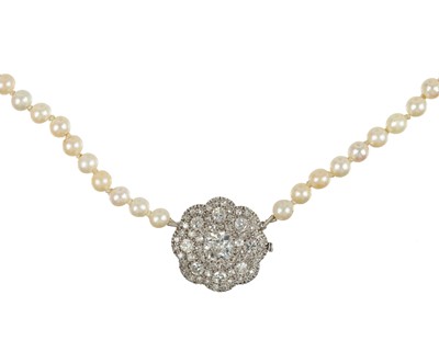 Lot 437 - An early 20th century graduated natural saltwater and cultured pearl necklace set a 1ct old mine cut diamond.