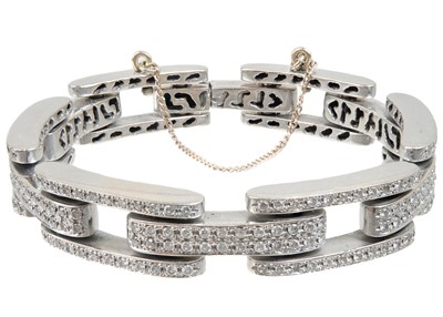Lot 446 - A contemporary heavy 18ct white gold diamond pave set bracelet.