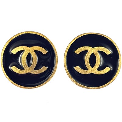 Lot 561 - A Chanel pair of CC gold-tone and black enamel circular clip earrings.
