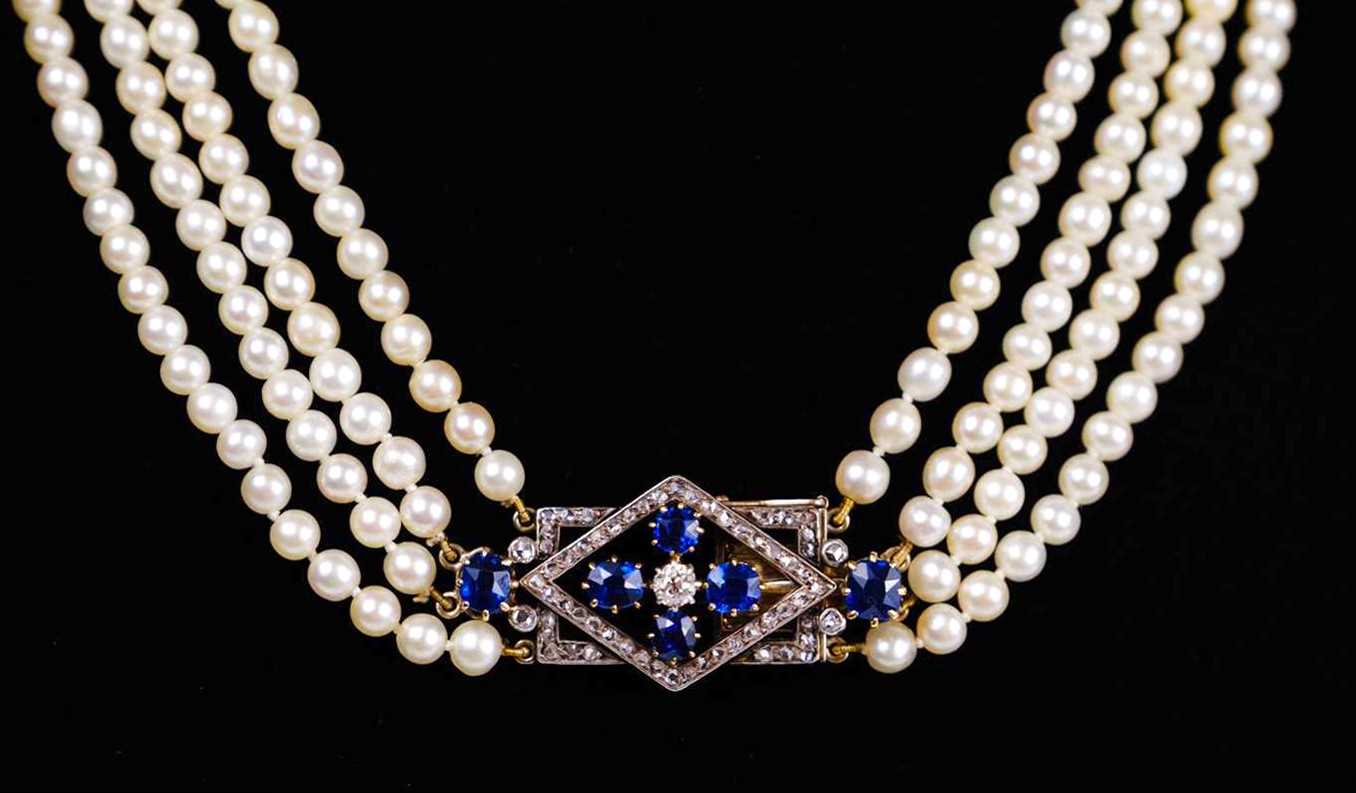 Lot 70 - An exquisite Art Deco four-row natural saltwater pearl choker with diamond and sapphire clasp.