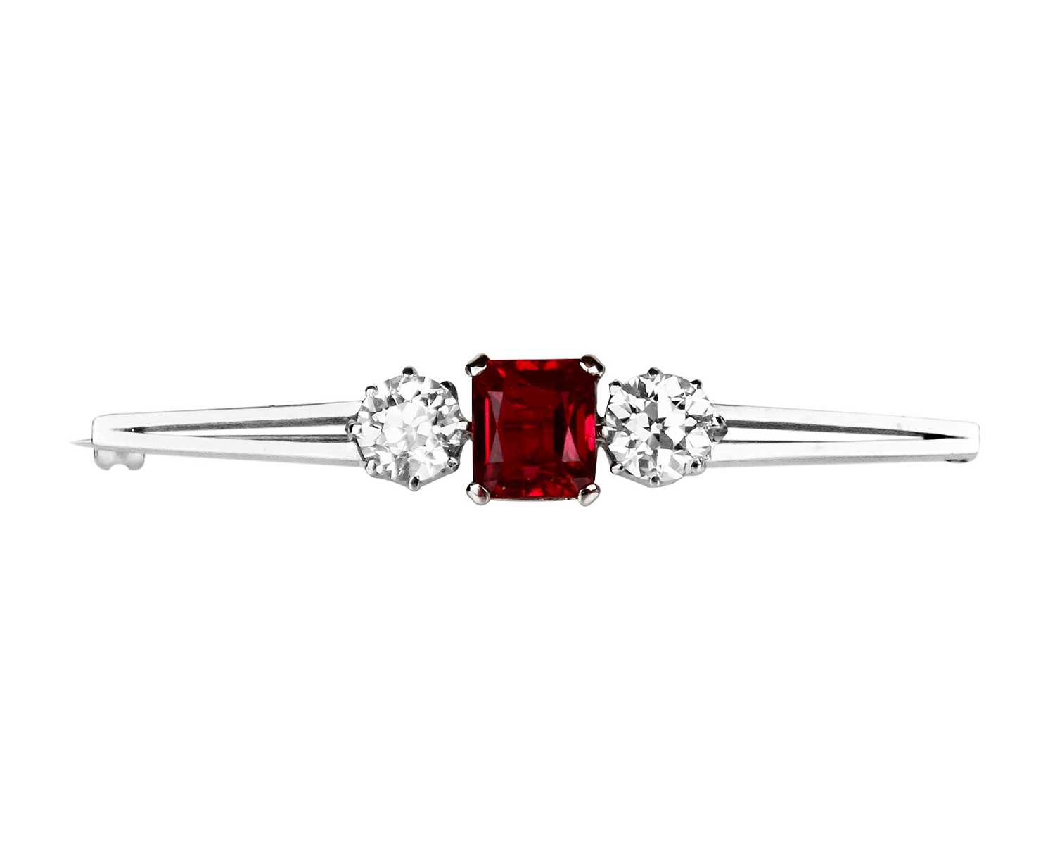 Lot 375 - An incredible 2ct diamond and 'pigeon blood' ruby platinum set three-stone bar brooch.