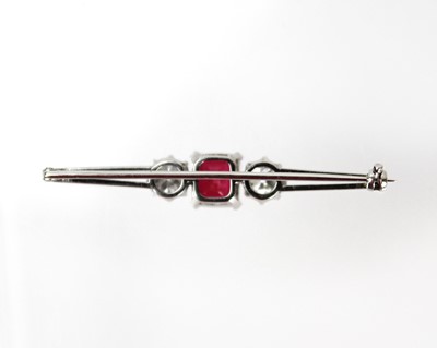 Lot 375 - An incredible 2ct diamond and 'pigeon blood' ruby platinum set three-stone bar brooch.
