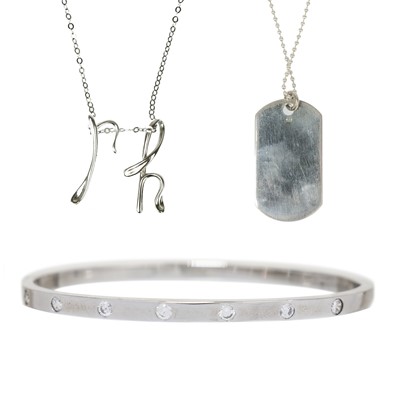 Lot 329 - A silver bangle, dog tag and pendant necklace.