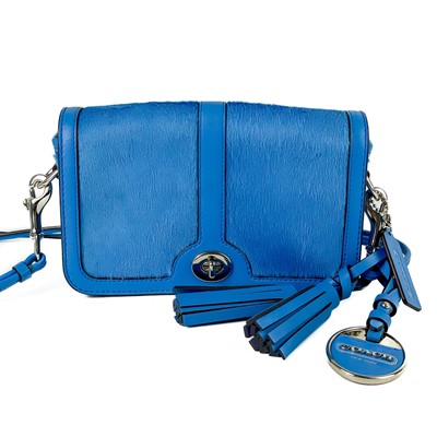 Lot 483 - A blue Coach leather and calf hair turn lock crossbody bag.