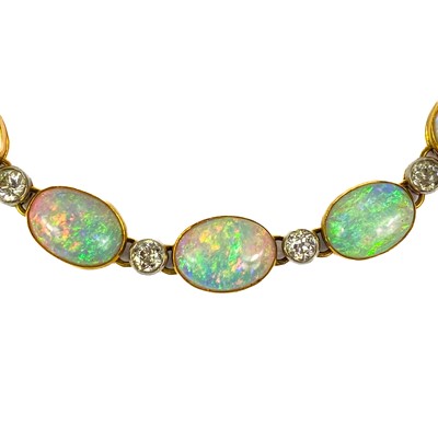 Lot 94 - An attractive early 20th century gold, diamond and blue opal set bracelet.