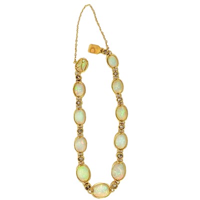 Lot 94 - An attractive early 20th century gold, diamond and blue opal set bracelet.