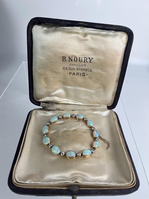 Lot 94 - An attractive early 20th century gold, diamond and blue opal set bracelet.