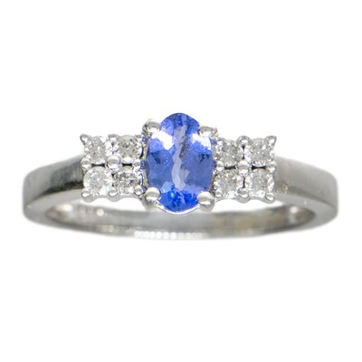 Lot 29 - A modern 9ct white gold tanzanite and diamond set ring.