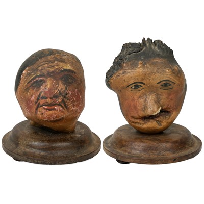 Lot 22 - A pair of folk art 'hedgerow' carved treen and painted heads.