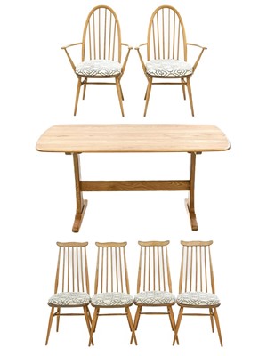 Lot 744 - An Ercol light elm and beech dining table and six chairs.