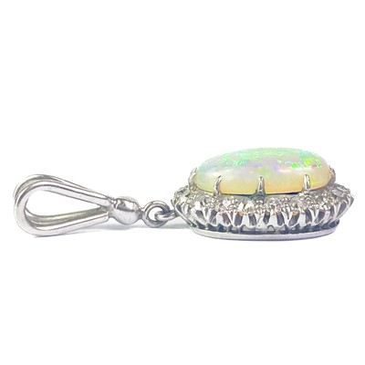 Lot 41 - A white opal and diamond cluster white gold pendant.