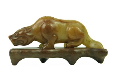 Lot 455 - A Chinese russet jade tiger, Qing Dynasty, 19th century.