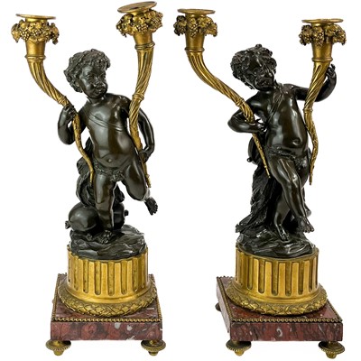 Lot 3 - A pair of French bronze and ormolu figural candelabra, after Clodion.