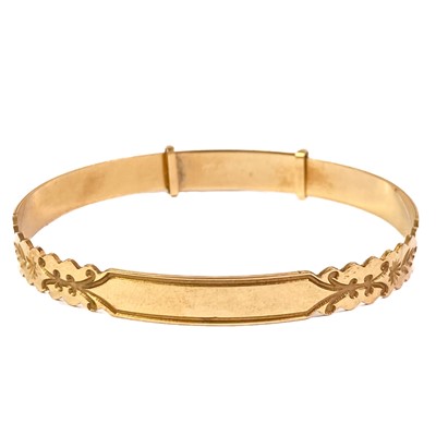 Lot 66 - A modern 9ct expanding bangle with engraved decoration.