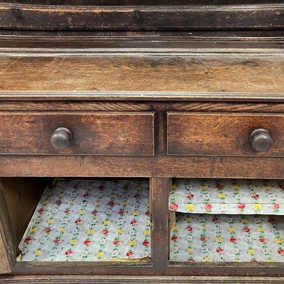 Lot 1018 - A George III oak dresser.