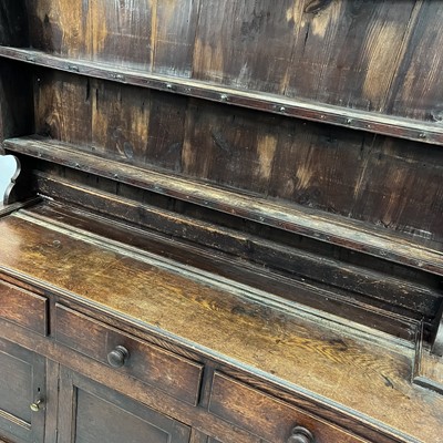Lot 1018 - A George III oak dresser.
