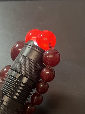 Lot 231 - A cherry amber bakelite necklace.