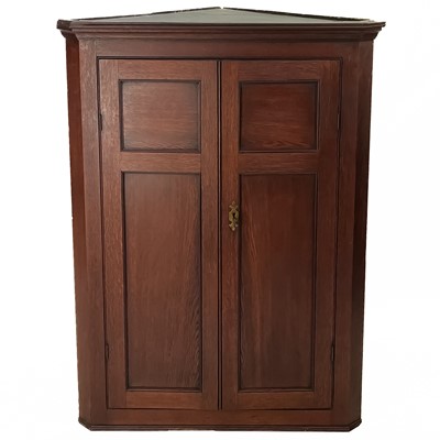 Lot 34 - A George III hanging oak corner cupboard.