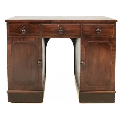 Lot 647 - A George III mahogany kneehole desk.