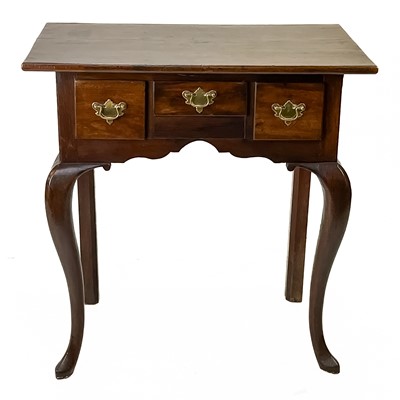 Lot 17 - A George III walnut and oak lowboy.