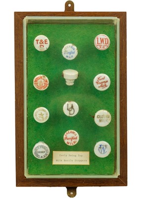 Lot 128 - A framed display of ceramic bottle stoppers.