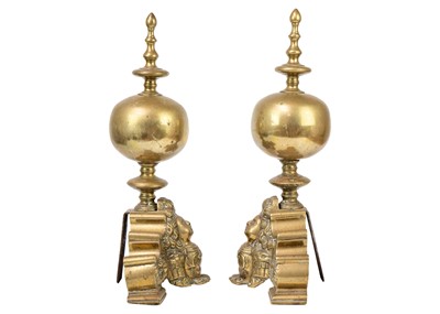 Lot 1017 - A pair of Dutch brass andirons.