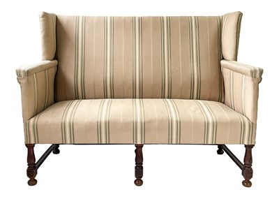 Lot 645 - A late Victorian mahogany frame winged back upholstered settee.
