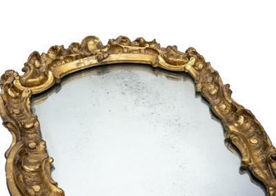 Lot 58 - An 18th century baroque wood carved gesso gilt mirror.