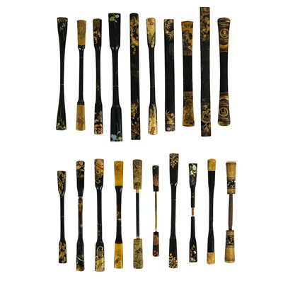 Lot 1031 - Twenty Japanese black and mainly gilt laquer kogai, 19th/20th century.