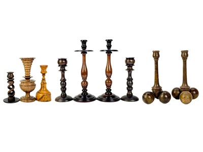 Lot 260 - A collection of nine treen candlesticks.
