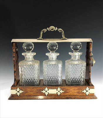 Lot 17 - An Edwardian oak tantalus, the metal handle...