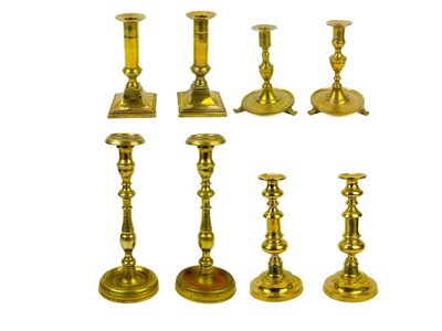 Lot 126 - A pair of 18th century brass candlesticks.