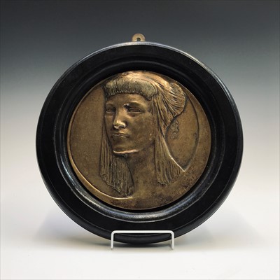 Lot 10 - An Art Deco period circular brass plaque after...