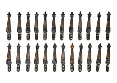 Lot 76 - A set of twenty-four early 20th century copper plated stair carpet grips of fleur-de-lys design.
