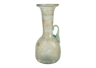 Lot 21 - An iridescent green glass vessel.