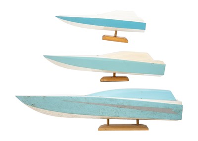 Lot 132 - Three graduating painted wood power boat models.
