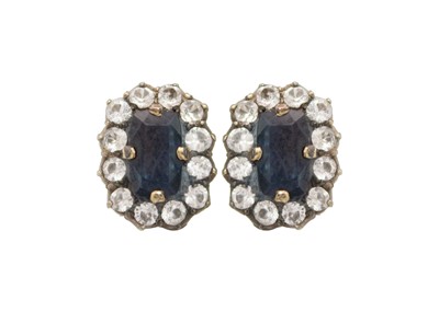 Lot 119 - A pair of blue and white sapphire cluster earrings.