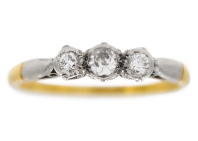 Lot 121 - An 18ct and platinum diamond set three-stone ring.
