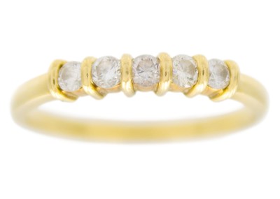 Lot 79 - An 18ct diamond set five-stone hoop ring.